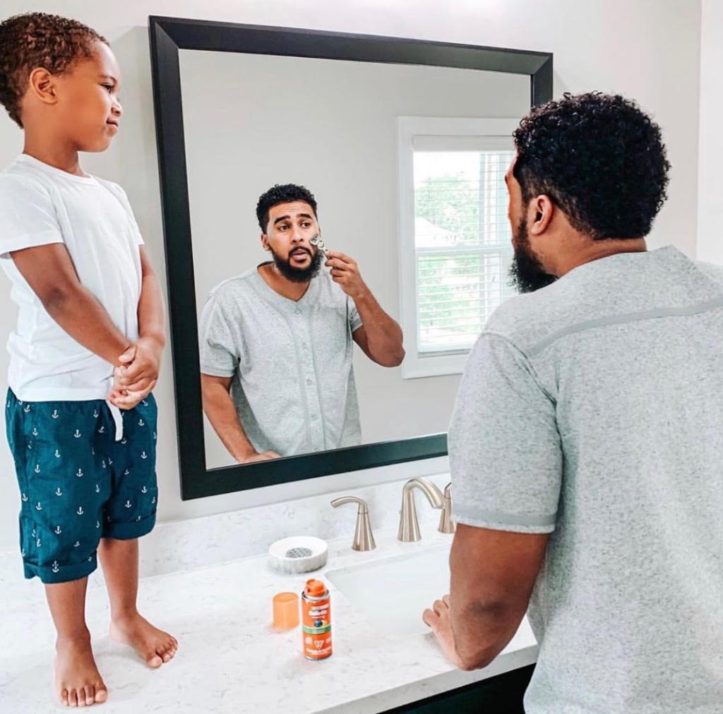 Adam Ali helps teach his young son how to shave by using a Gillette razor. 