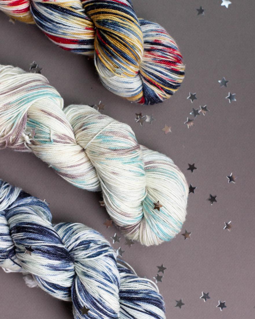 Gleaming &amp; glittering with silver sparkle &amp; wondrous surprises for all, July's Sock Crate Membership is Knitologie's Sparkling Sock-- a glittering blend of 70% SW Merino, 20% Nylon &amp; 10% Stellina 🧦✨ From top to bottom: Grandstand 🎪Horseback Dancer 🎠 and Starlight 🌌