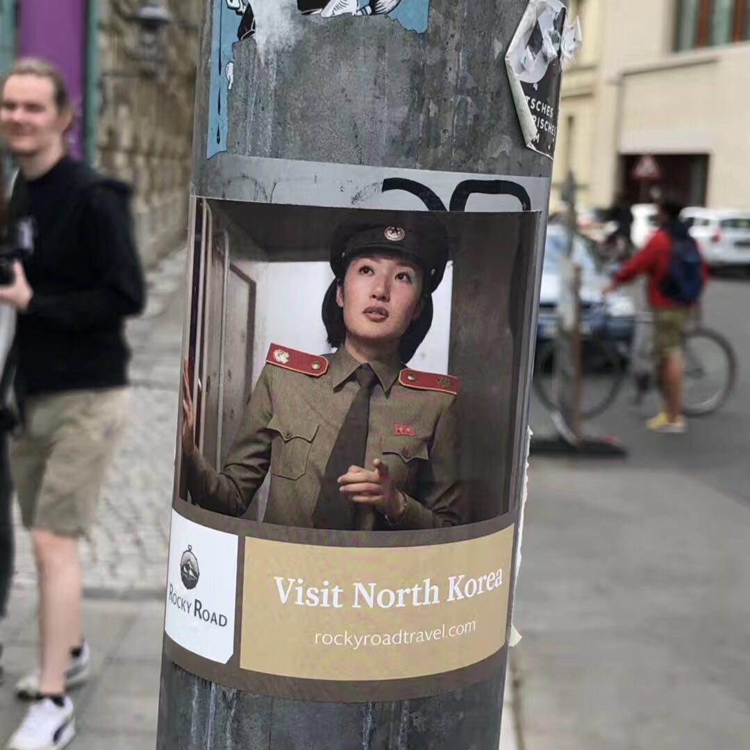 A poster is seen in a street in #Berlin, Germany, to promote travels to North Korea. #DPRK