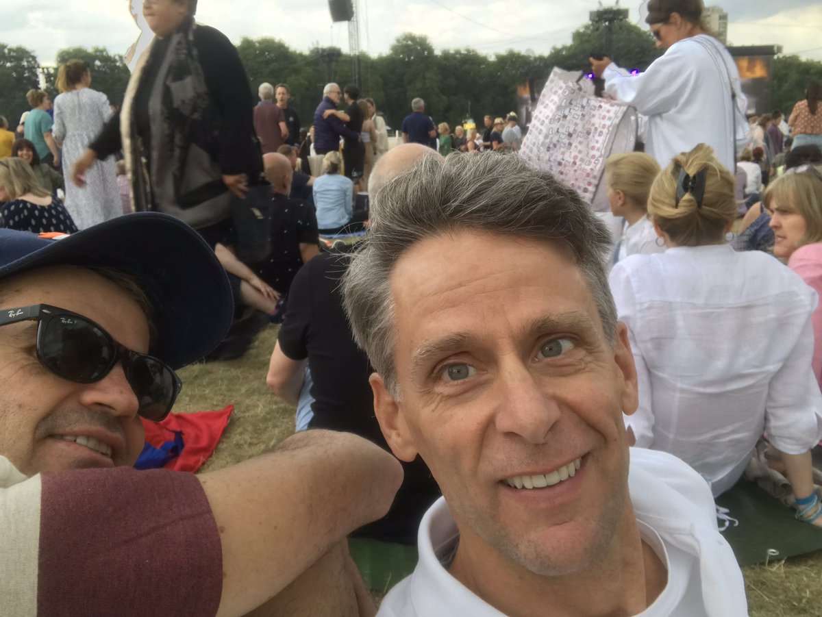 scottcapurro's tweet photo. Brian Ferry is fab but someone has to upgrade us. We’re sitting on a lawn!! #upgradeplease #HydePark @BarbraStreisand https://t.co/g2Rcez87gJ