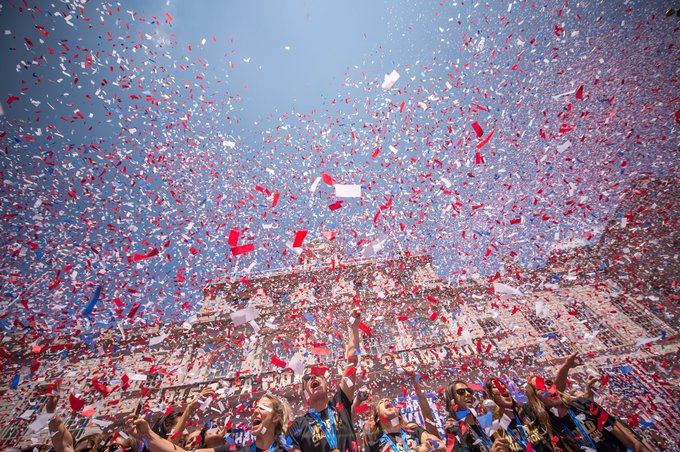 Confetti raining at city hall with women’s soccer team cheering