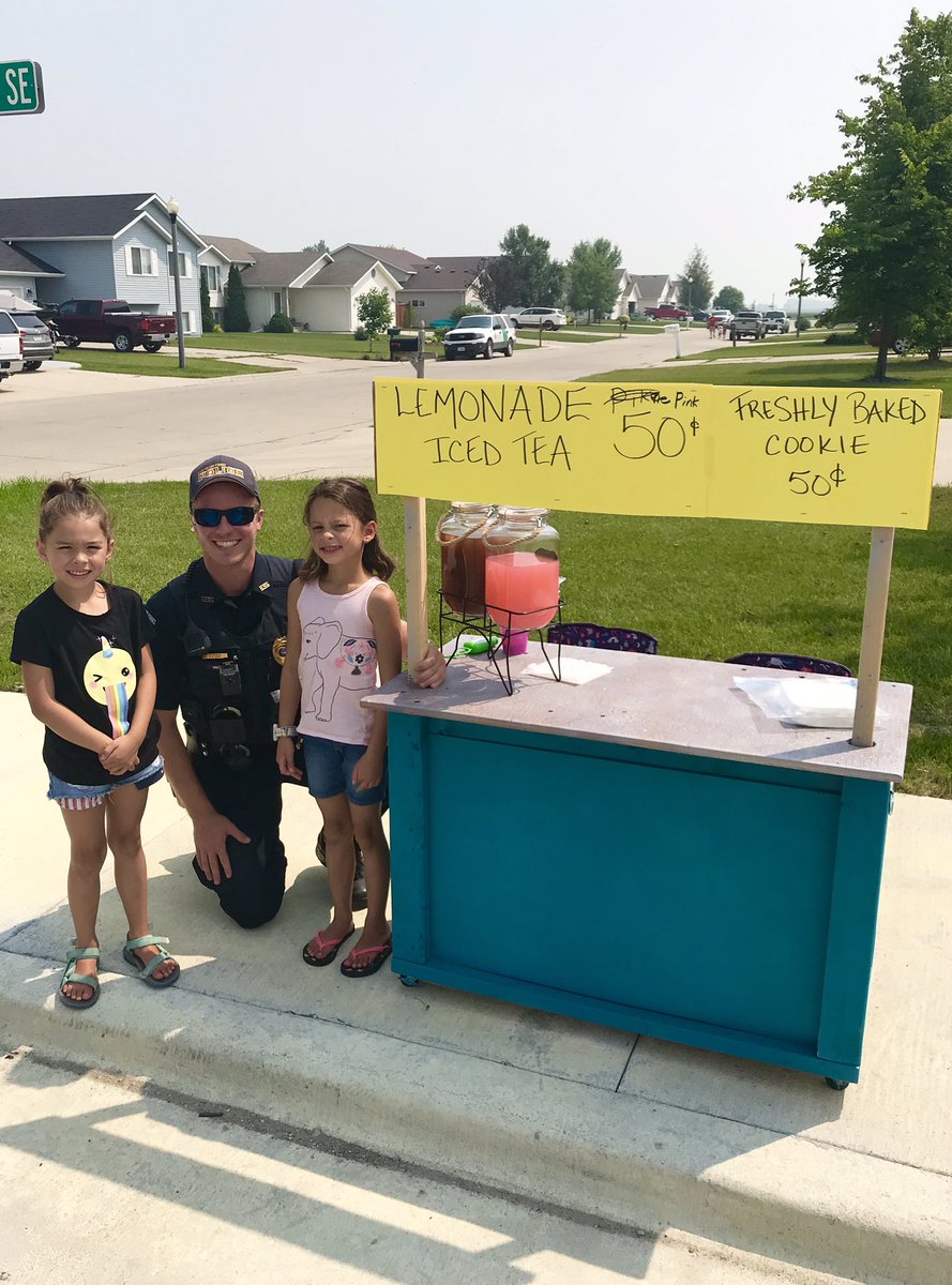 Officer Hajicek is enjoying himself several glasses of lemonade on this hot day. He recommends all the stands around town!