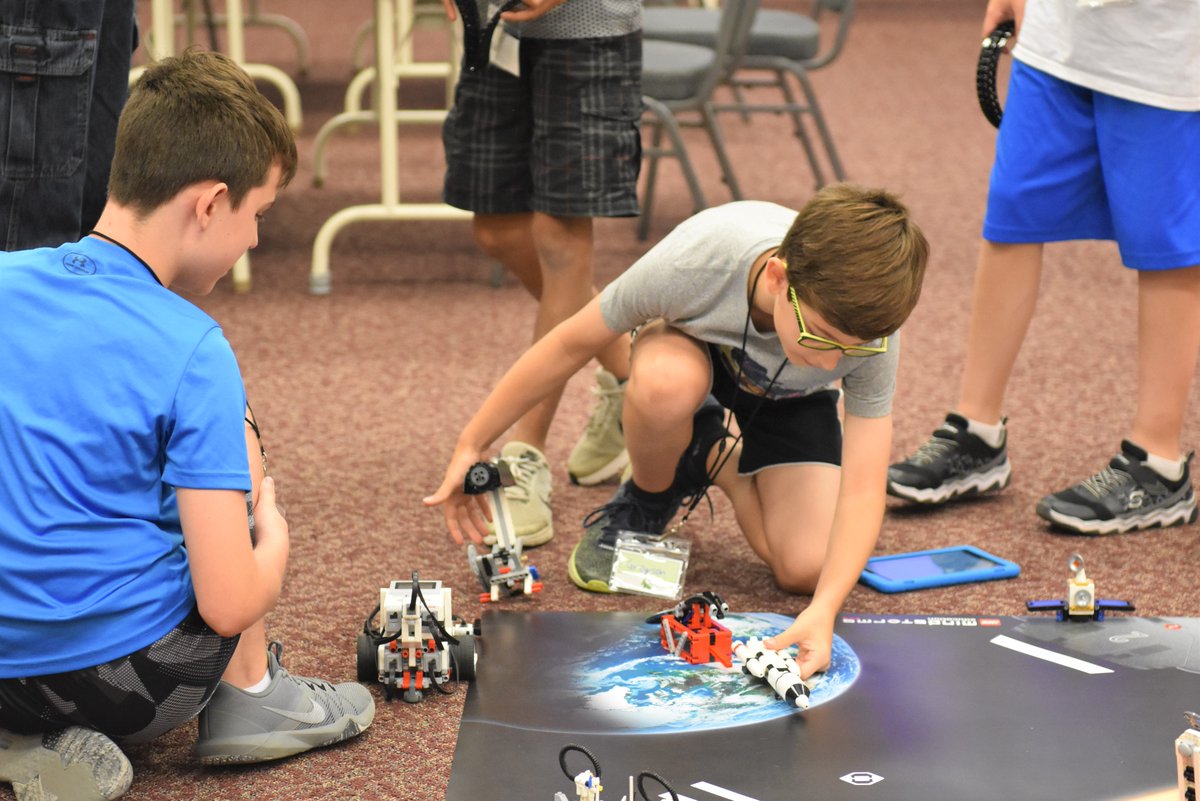 Connecting blocks:  at the Lego Robotics Inventors Club at IU13, once the robot is constructed, the building isn't done.  Today, campers were experimenting with block coding to direct their machines along a path, avoiding obstacles on the way. #robotics
