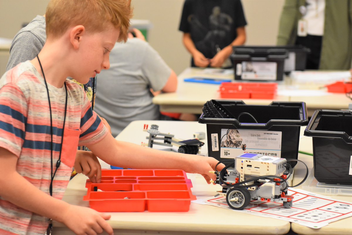 IU13's tweet photo. Connecting blocks:  at the Lego Robotics Inventors Club at IU13, once the robot is constructed, the building isn't done.  Today, campers were experimenting with block coding to direct their machines along a path, avoiding obstacles on the way. #robotics https://t.co/g3RcICQ1Gy