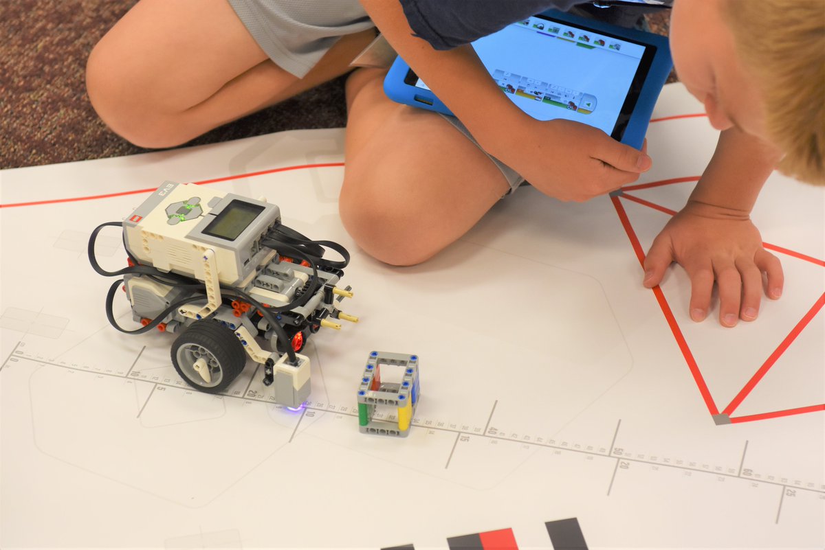 IU13's tweet photo. Connecting blocks:  at the Lego Robotics Inventors Club at IU13, once the robot is constructed, the building isn't done.  Today, campers were experimenting with block coding to direct their machines along a path, avoiding obstacles on the way. #robotics https://t.co/g3RcICQ1Gy