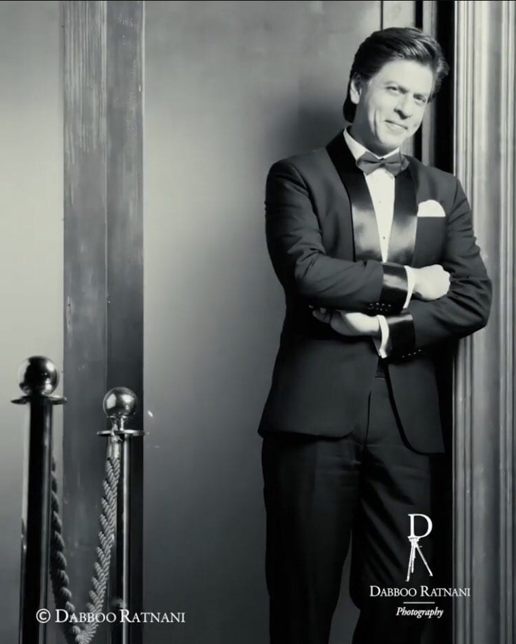 TeamSRKWarriors's tweet photo. Dapper, elegant &amp; stylish all at once, #BTS photoshoot of @iamsrk with @DabbooRatnani 🔥 https://t.co/nKqUJg7A3E