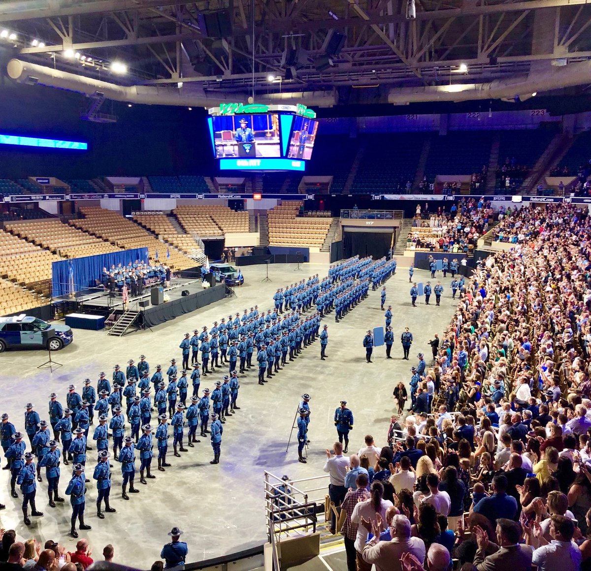 MassStatePolice's tweet photo. A standing ovation for the newest MSP Troopers as the badge pinning is completed. The graduates are about to be inspected by @MassLtGov and MSP Col @KerryGilpin. https://t.co/caRYB4SuVG
