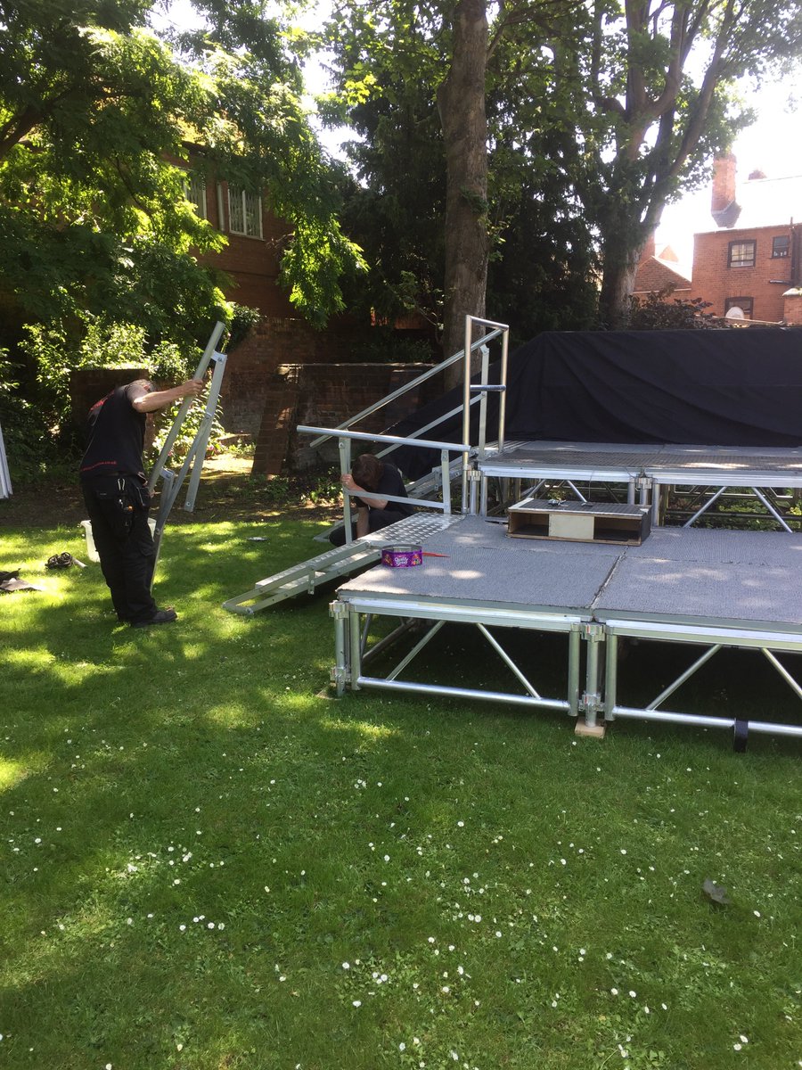 WorcesterRep's tweet photo. The technical team are hard at work in The Commandery Gardens putting up the stage! Time for a well earned tea break! 💛☕️☀️ #putthekettleon #SummerinWorcester #Austentatious #paintthetownyellow #behindthescenes #notlongnow @worcestermuseum https://t.co/fzkhNemCkq