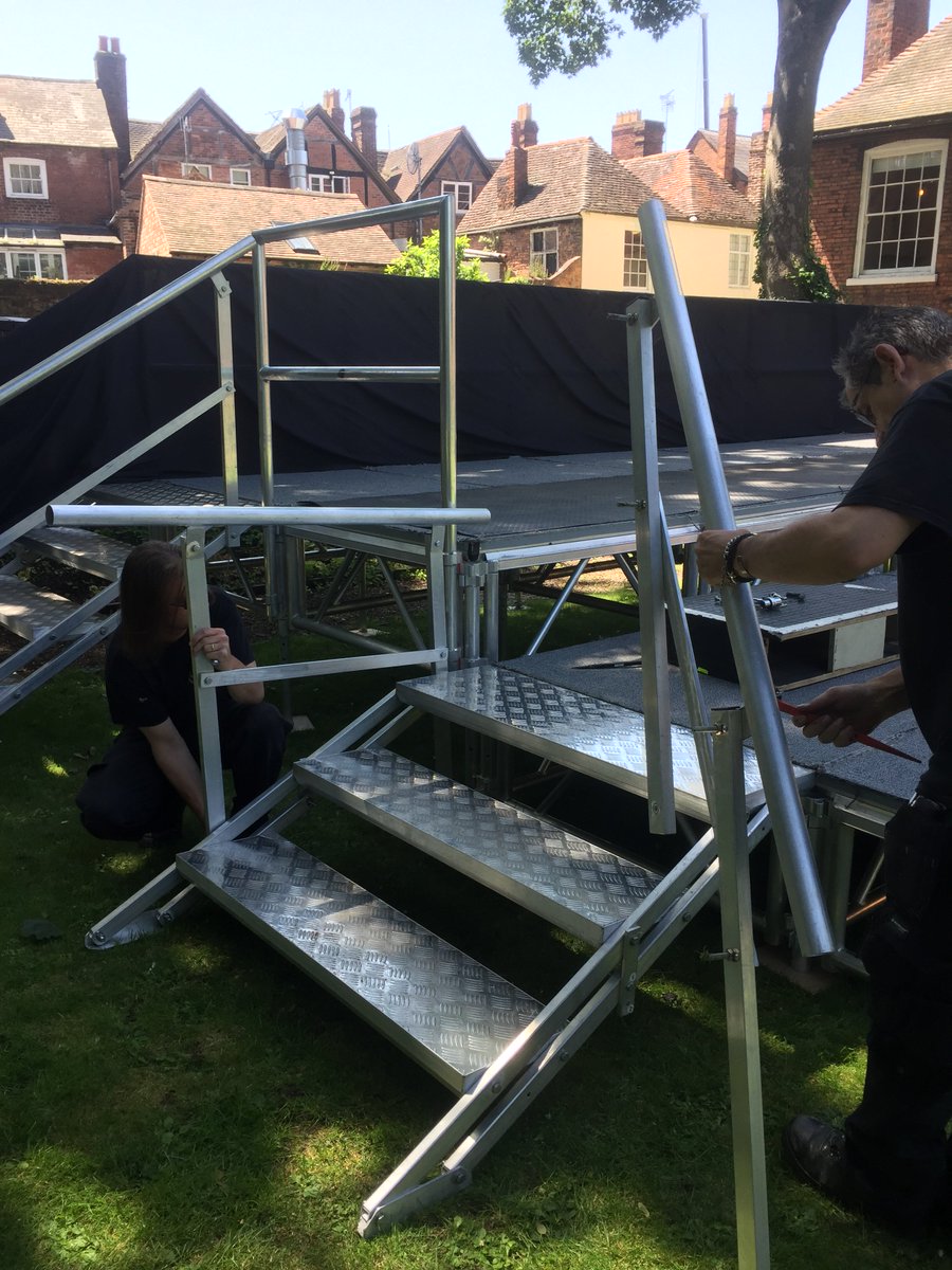 WorcesterRep's tweet photo. The technical team are hard at work in The Commandery Gardens putting up the stage! Time for a well earned tea break! 💛☕️☀️ #putthekettleon #SummerinWorcester #Austentatious #paintthetownyellow #behindthescenes #notlongnow @worcestermuseum https://t.co/fzkhNemCkq