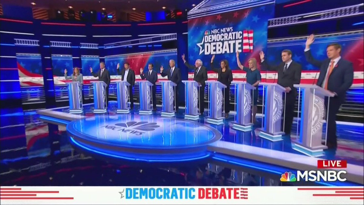 TheDailyShow's tweet image. "Candidates, by show of hands: How many of you have no idea who the woman on the end is?" #DemDebate2