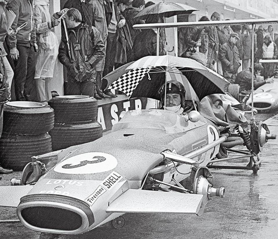 RetroRacingCo's tweet photo. Graham Hill gathers his thoughts in the rain ahead of the 1968 German GP.  What would have been going through his head seeing the conditions at the Nurburgring.... https://t.co/X6U9NJjGC9