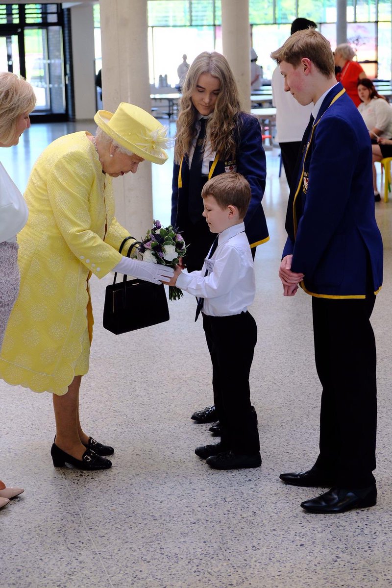 RoyalFamily's tweet photo. Archie gives Her Majesty a beautiful posy at the end of her visit to @Greenfaulds_HS 💐 https://t.co/WAFfJqW7Gc