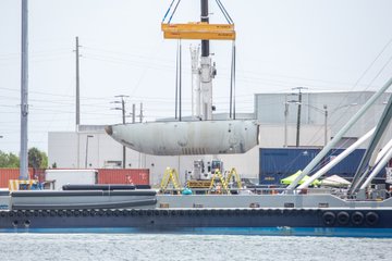 One half of the Falcon 9/Heavy nosecone, known as a Fairing, being lifted off the deck of the ship that caught it, GO Ms. Tree