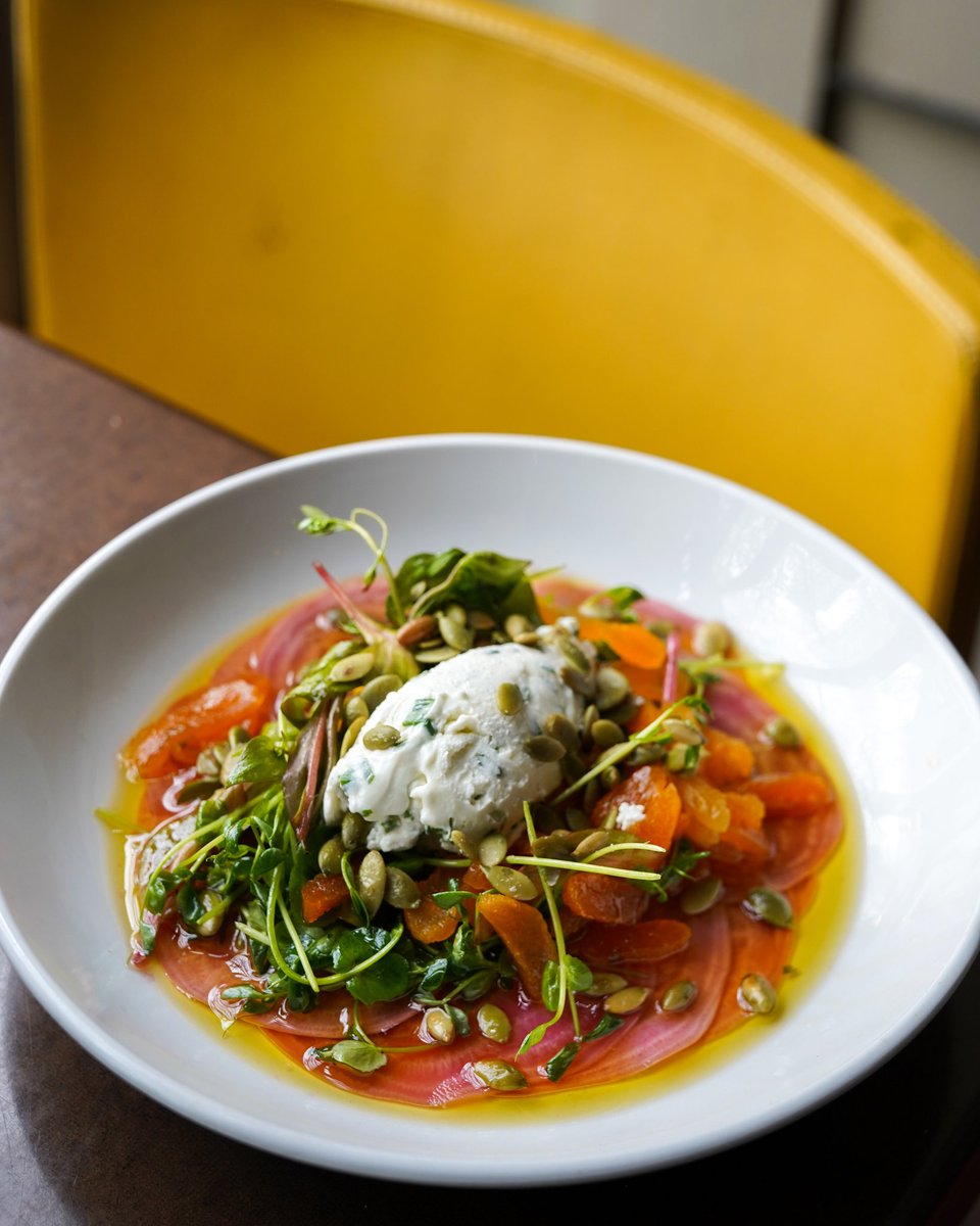 Our beautiful beet salad is topped with goat cheese, pea vines and pepitas. 💞