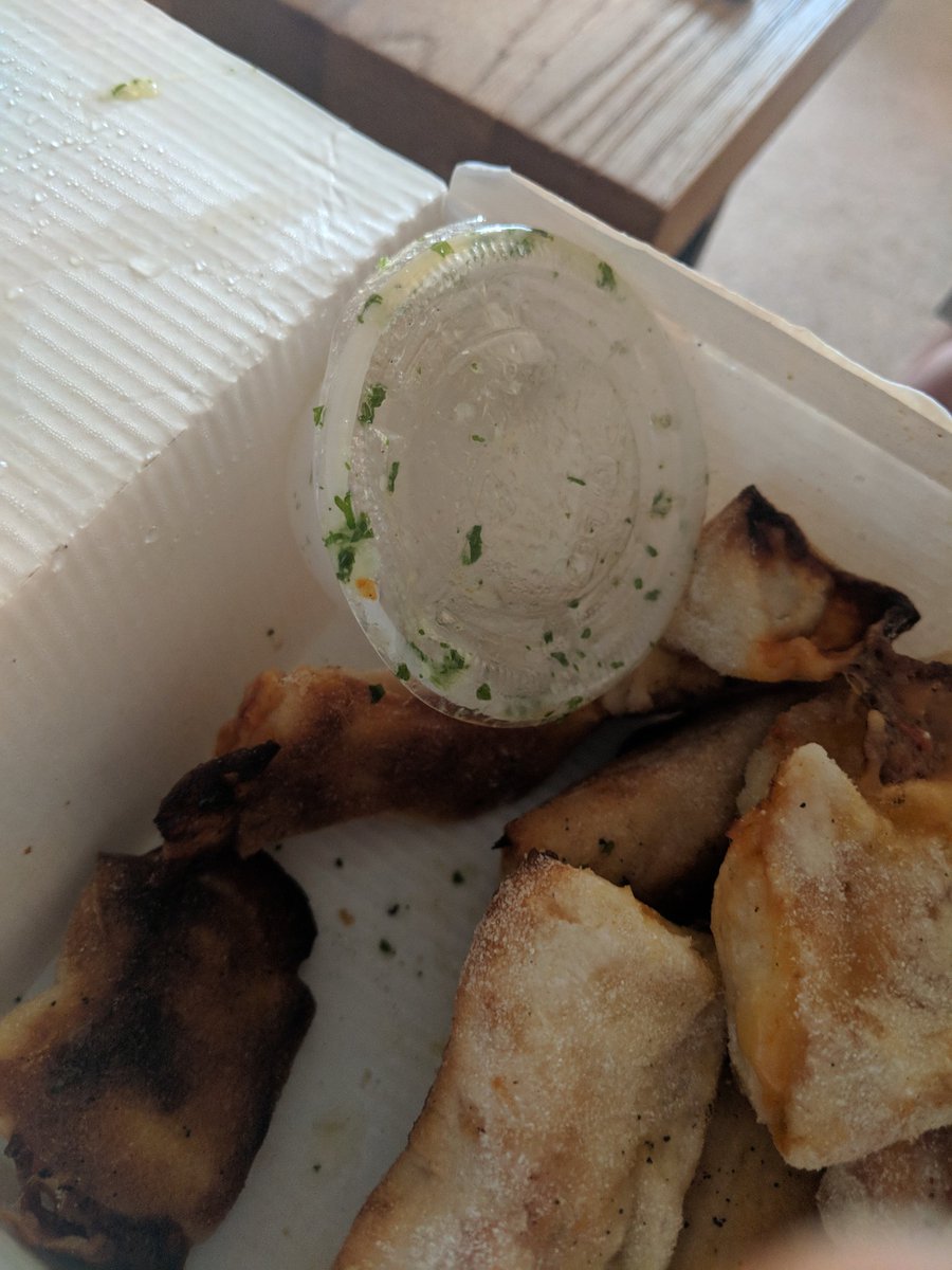 Bullski44's tweet photo. @love_prezzo ordered my first Prezzo takeaway and very disappointed. A defective garlic sauce tub means it's spilled into the box, and neither pizza has been cut into slices https://t.co/H7VEcryZqL