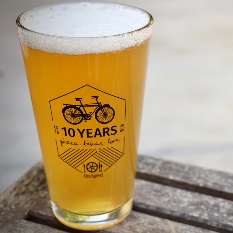 OneSpeedPizza's tweet photo. Our anniversary month may be drawing to a close, but you can hold on to a piece of the party. Pint Glasses and Anniversary Shirts are available for sale, while supplies last! #PizzaBikesLove #OneSpeedPizza #MoreThanPizza #Anniversary #10Years https://t.co/SACjTDnQTp