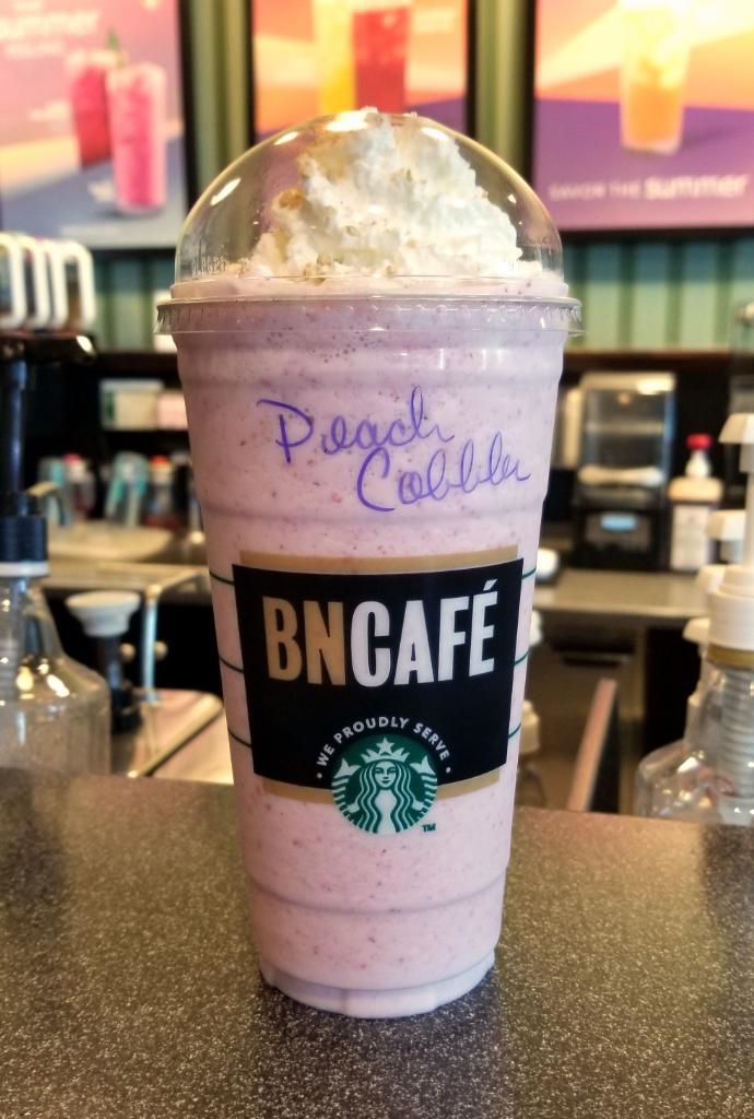 BNMinot's tweet photo. July is #Frappuccino month here in our #BNCafe and we're #celebrating early! 🎉 Today's #FeaturedFrappuccino is the #PeachCobbler Frappuccino! This is a staff creation, and we're absolutely #obsessed with it. Stop in today for a Venti! #yummy #getinmybelly https://t.co/l9aALzsRMH