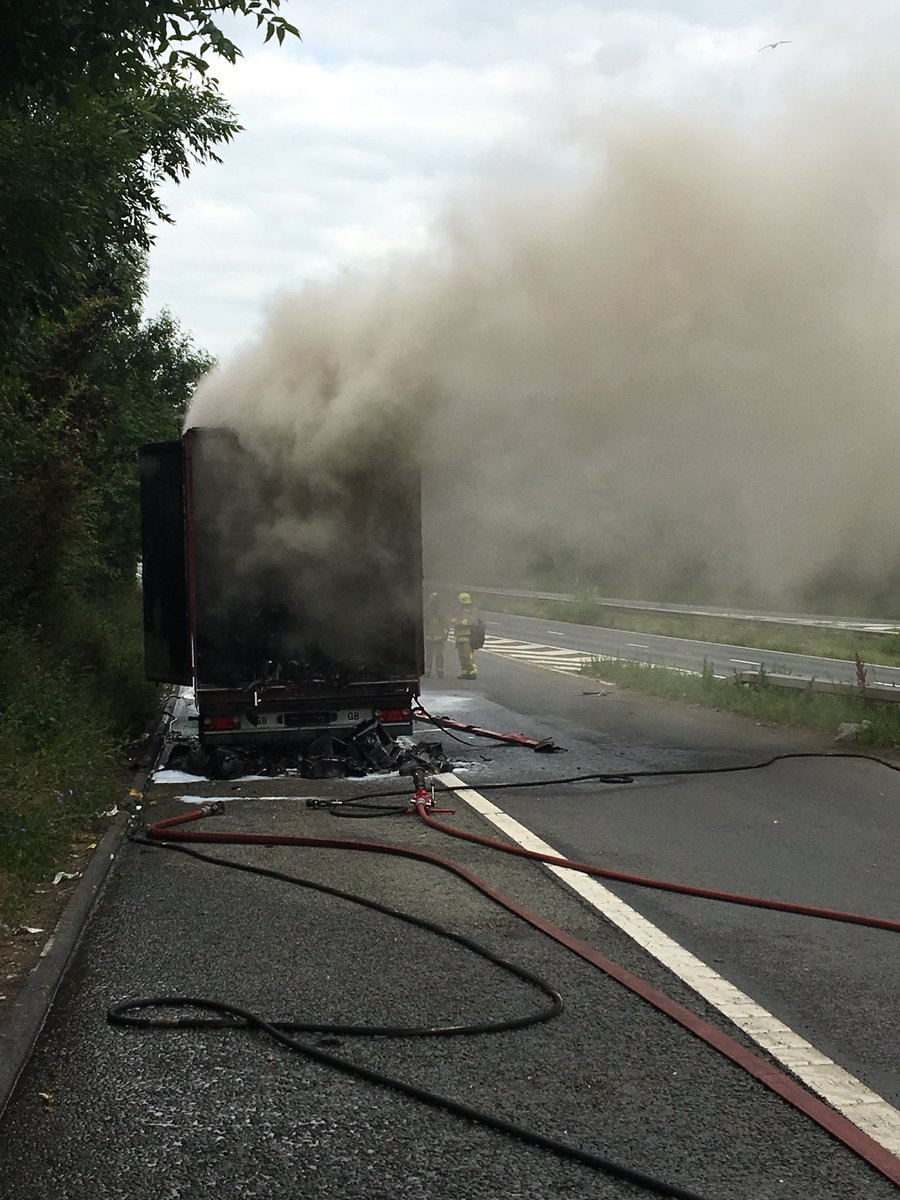 KentPoliceRoads's tweet photo. Update from M2 Medway Services Lorry fire. Smoke heavy across both carriageways @kentfirerescue dealing. As soon as we can reopen the road when safe to do so we will. Expected long delays coastbound. GS https://t.co/L8LPsH6zCm