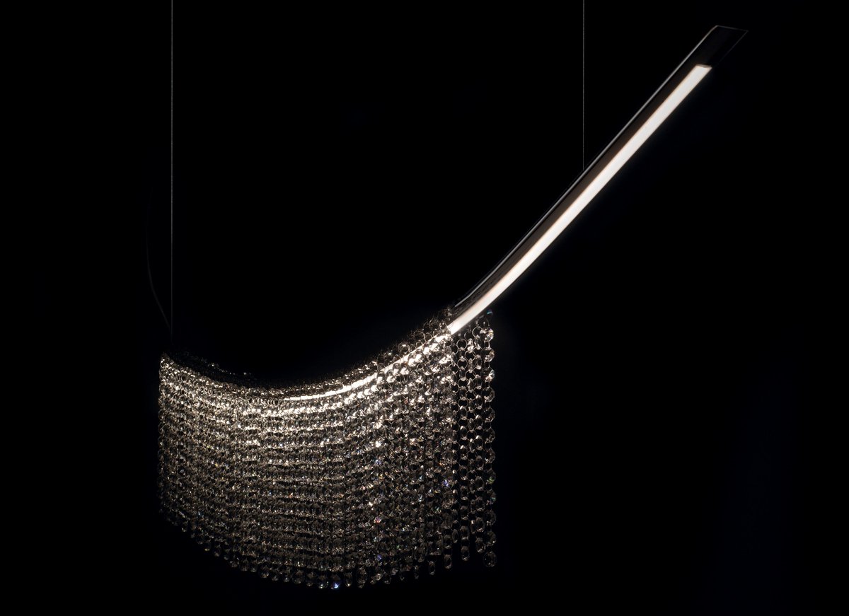 The stunning Virgola, a comma shaped contemporary design piece, with cascading crystals on a single curve. Simplicity, sophistication and high style make this incredible light an exquisite statement piece.