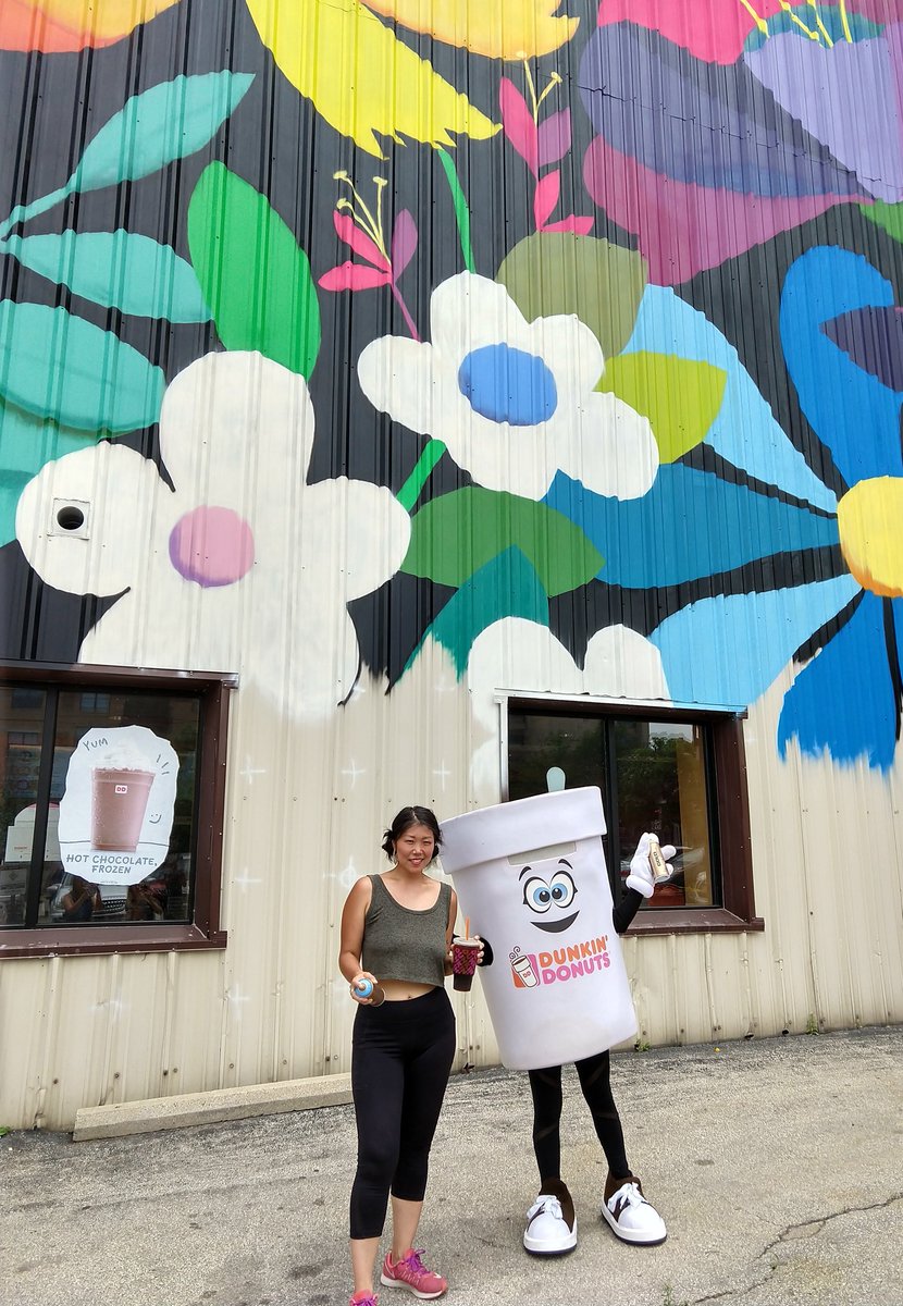 MilwDowntown's tweet image. Today outside the @dunkindonuts store near Wisconsin Ave &amp;amp; James Lovell, "Cuppy" joined artist Emma Daisy Gertel as she worked on the new Westown Gateway mural!

Watch the mural take root &amp;amp; bloom this summer 🌺