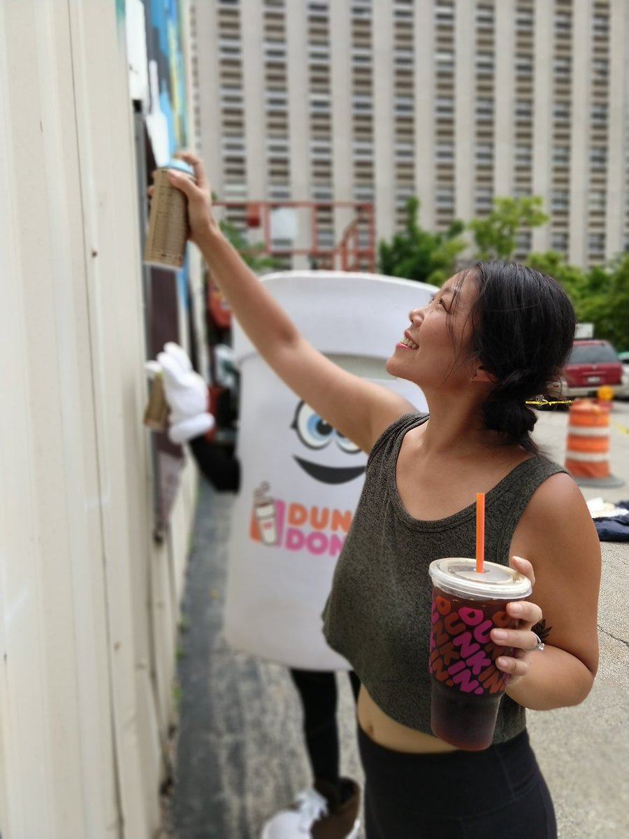 MilwDowntown's tweet image. Today outside the @dunkindonuts store near Wisconsin Ave &amp;amp; James Lovell, "Cuppy" joined artist Emma Daisy Gertel as she worked on the new Westown Gateway mural!

Watch the mural take root &amp;amp; bloom this summer 🌺