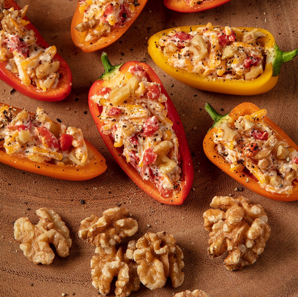#StuffedPeppers – A tried and true #appetizer for #summerparties. These beauties are stuffed with cream cheese, sharp cheddar cheese, #pimentos and chopped #MarianiWalnuts. Finish them off with a healthy dusting of fresh ground pepper.
