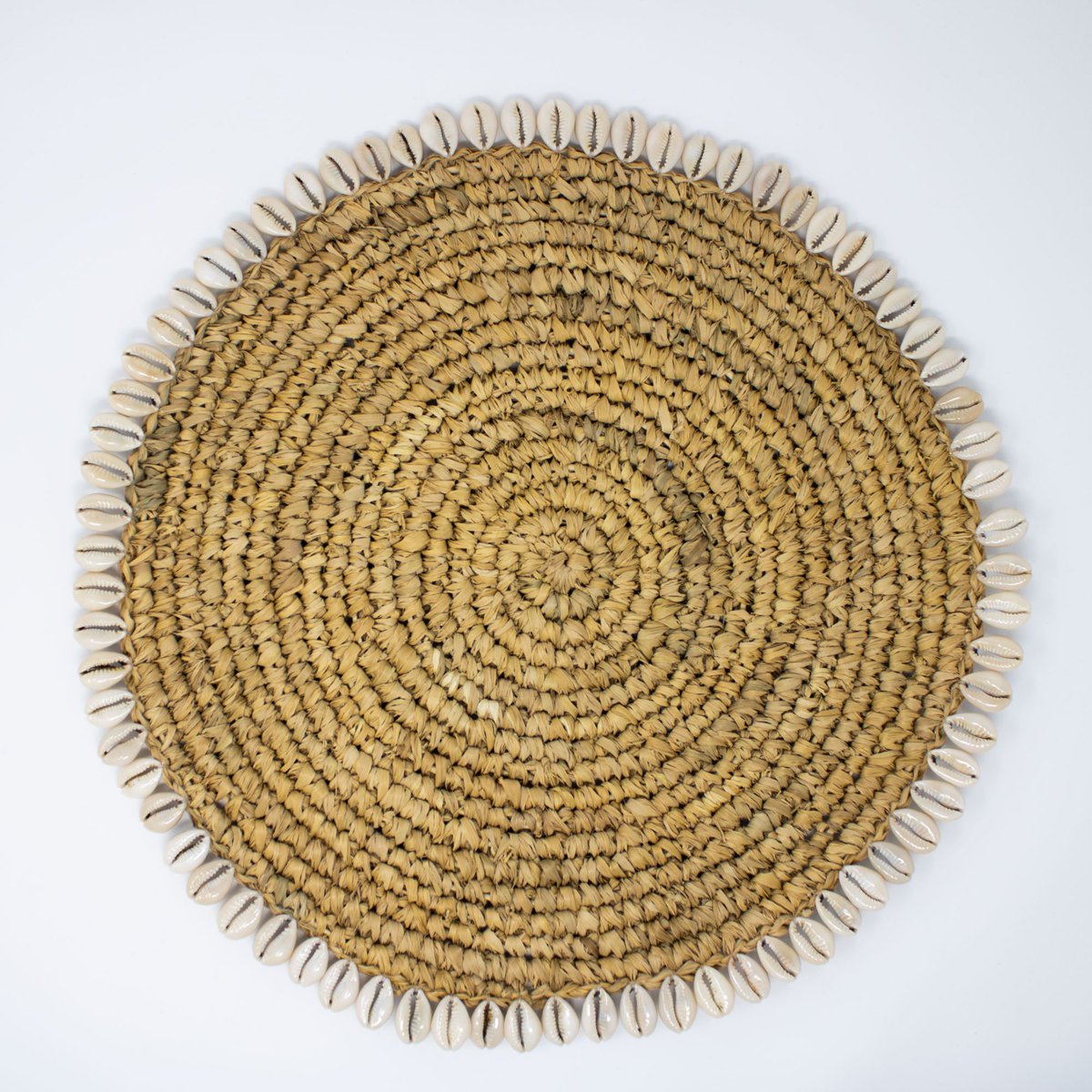 Simple and earthy, this wonderfully tactile placemat is hand-woven from sea grass and features cowrie shell edging. Perfect to add a touch of understated glamour to any table. 
#duskfurniture #homedecor #handwoven