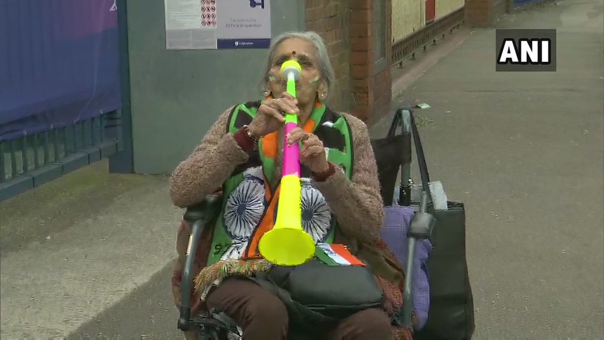 ANI's tweet photo. 87 year old Charulata Patel who was seen cheering for India in the stands during #BANvIND match: India will win the world cup I am sure. I pray to Lord Ganesha that India wins. I bless the team always. When Kapil paaji won the World Cup in 1983, I was there as well. #CWC19 https://t.co/Y35NmXmbCt