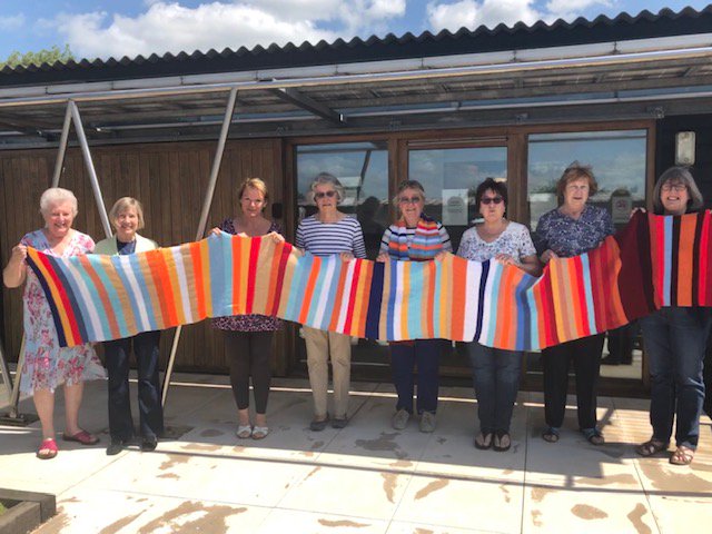 WomensInstitute's tweet photo. Don't forget you can knit your own smaller climate scarf, like the one knitted by members of @CambridgeFedWI, using our step-by-step guide on My WI: https://t.co/9lvbV7keoF! #ShowYourStripes https://t.co/iWt4vAlWgi