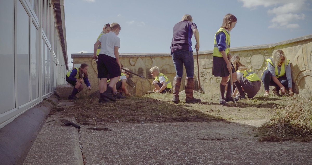 LymingtonJunior's tweet photo. Volunteer gardeners working hard today at the @wightlinkferry terminal. Proud to be involved in this community project. Thanks to Mrs Moossun and the children for their hard work! Watch this space to see how the design develops...#CommunityKids https://t.co/7X1K7cdqPv
