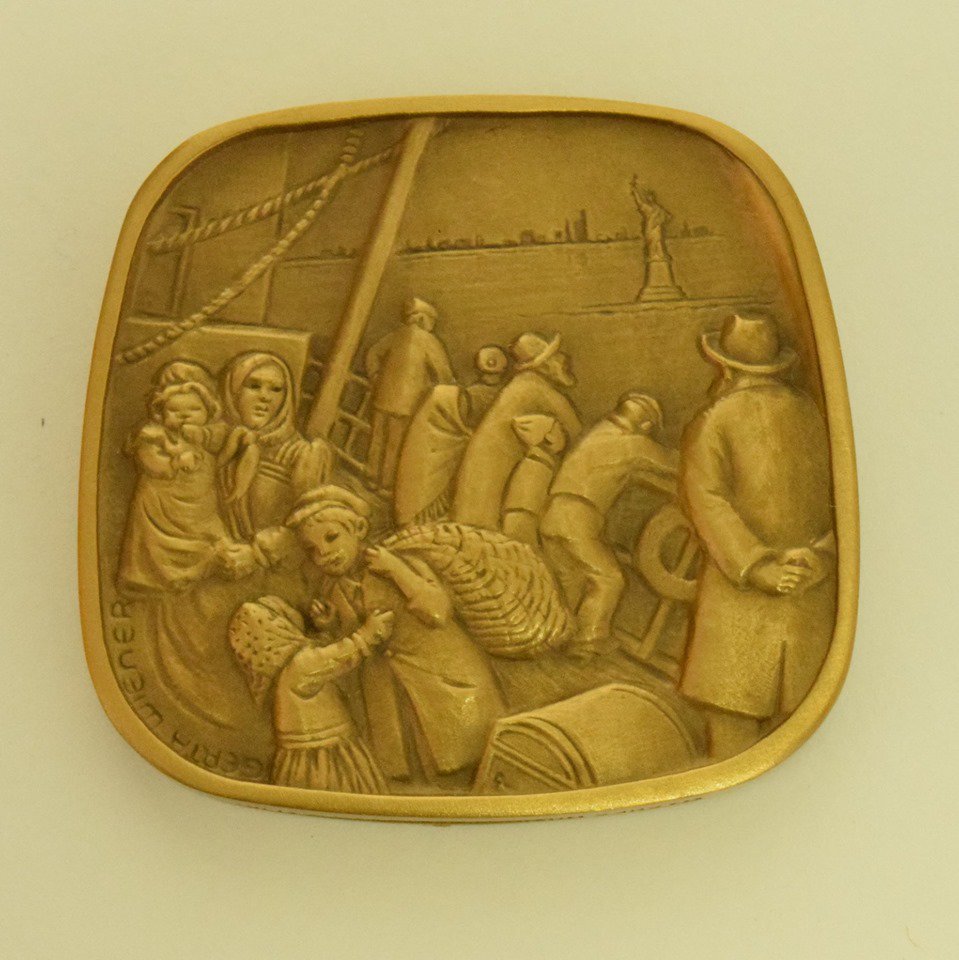 the Hanukkah story, events throughout Jewish history, and Anson’s own journey fleeing the Holocaust. Similarly, the reverse of Emma Lazarus’s Jewish-American Hall of Fame medal depicts immigrants looking hopefully towards the Statue of Liberty, where Lazarus’s poem (2/3)