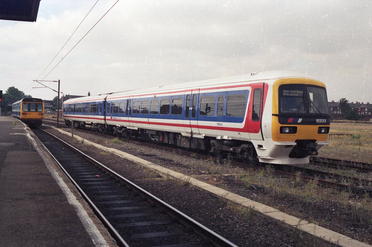 Summer 1991, the first of the Class 165 Thames Turbos stands at York station with an arriving Class 142 Pacer. #Class165 #NSE #Class142 #York