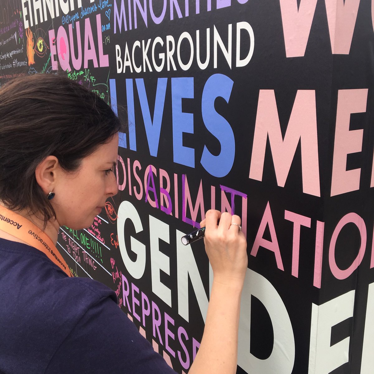 hearinaustin's tweet photo. @EliseRoy #UnconsciousBias #DisabilityDesign #Opportunity @CEOAction  Alt Text: Kate, woman with brown hair, writing on wall with words equal, minority, background, lives, gender and respresent. Kate is writing disability on top of discrimination. https://t.co/Q3Xkw2Sfrr