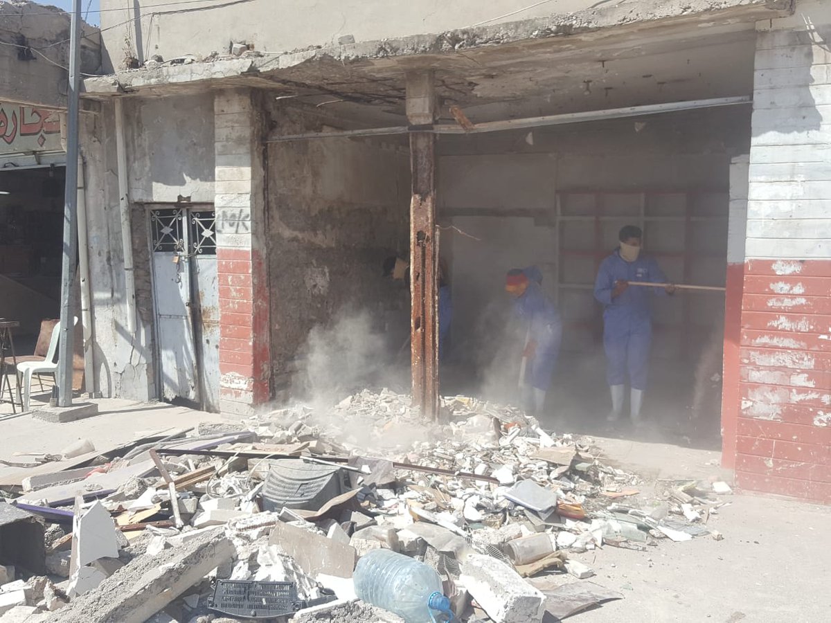 IOMIraq's tweet photo. Al-Shifaa market in #Mosul was heavily damaged during conflict w/ #ISIL. To recover the market, IOM launched a debris-removal campaign, hiring local workers. Once rubble is removed, IOM will support the shop owners to reopen their businesses. Supported by @KfWpress. #IraqRecovery https://t.co/3i2NjwsxzQ