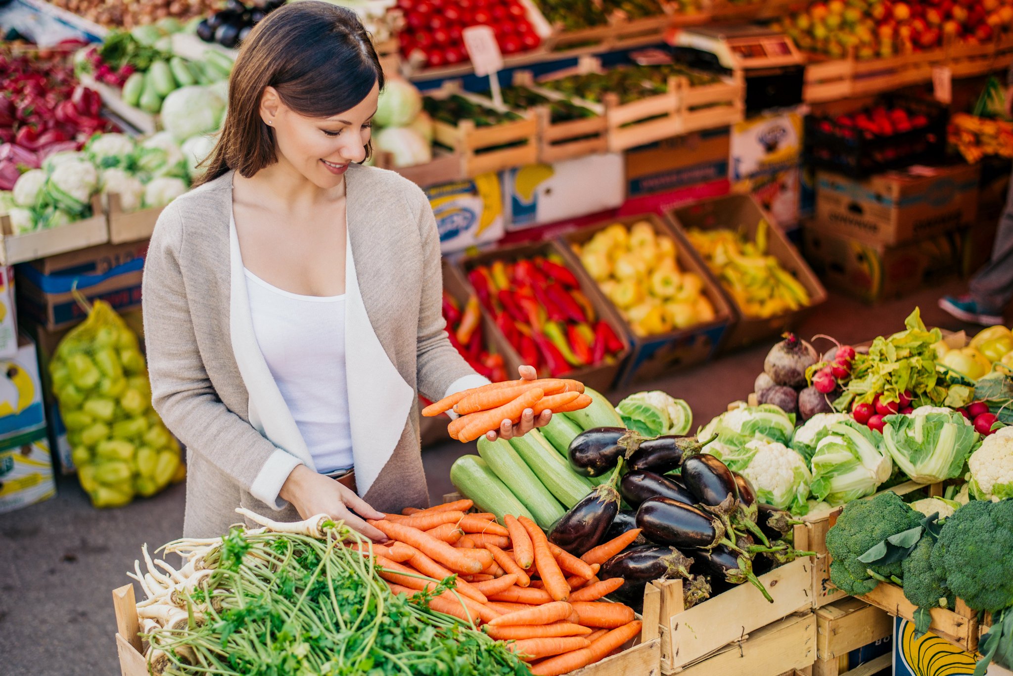Person doing grocery shopping with focus on fresh produce
