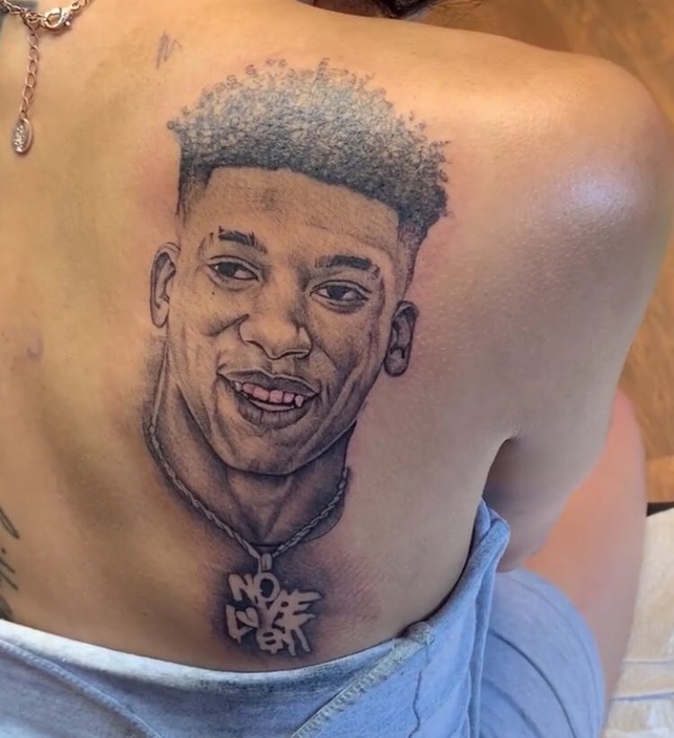 NLE Choppa’s girlfriend got his face tatted on her back.