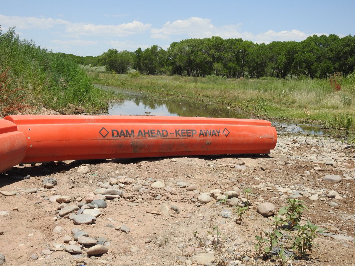 ABQFloodControl's tweet photo. July 5, 2019- #AMAFCA #FacilityFridays A recent addition to the North Diversion Channel outfall are some very large orange booms. These booms are put in place to catch floatable debris and help protect the maintenance road! https://t.co/iHkr19t6dv