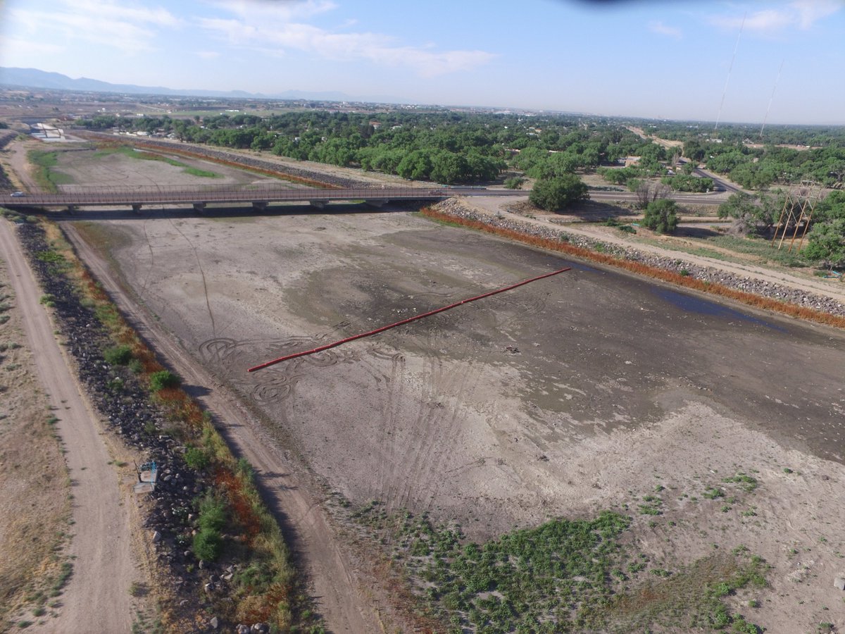 ABQFloodControl's tweet photo. July 5, 2019- #AMAFCA #FacilityFridays A recent addition to the North Diversion Channel outfall are some very large orange booms. These booms are put in place to catch floatable debris and help protect the maintenance road! https://t.co/iHkr19t6dv