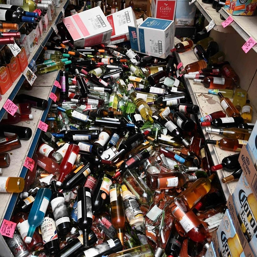 BlackRoomMedia1's tweet photo. Bottles of broken wine on the floor of a liquor store in #RidgecrestCa where a 7.1 magnitude earthquake hit. https://t.co/g7kSLi1ce3
