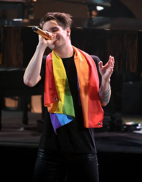 WeHeartTrans's tweet image. Brendon Urie wearing the LGBTQ+ pride flag!