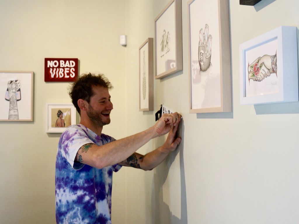 Local artist and illustrator Jarred Weinstein prepping for his Art Opening Thursday 6-9p with Beats & Coffee featuring Kon Sci of Mindsone and Soulful Twist Food Truck. “Babes, Waves and all the Craves” is on display through April.