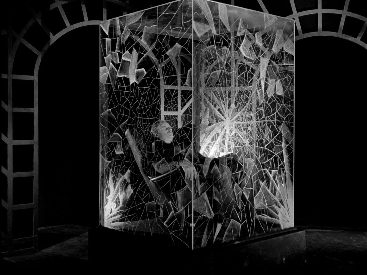 Professor Keller, crazed (sitting in his broken glass box)