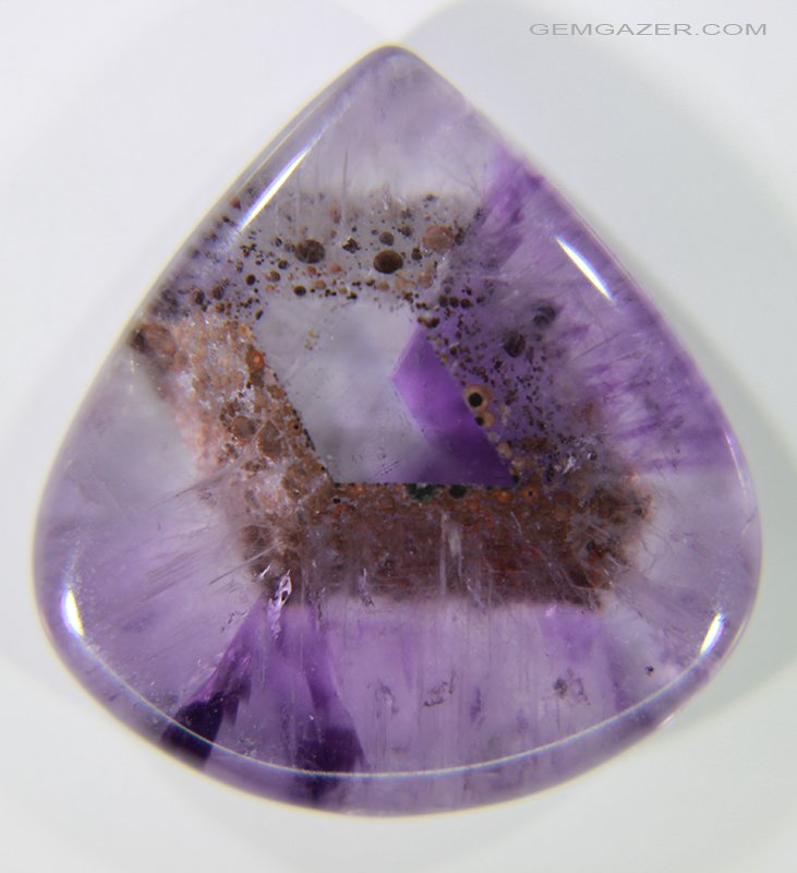 gemgazer's tweet photo. Amethyst cabochon from Brazil with trapiche-like colour zoning and a phantom growth feature surrounded with reddish-brown Goethite crystals.
https://t.co/0epIOFGM6a
#gemstone
#photomicrography
#gemInclusions
#gemology https://t.co/Gwr4vbwitm