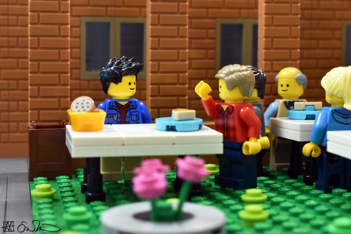 LGS is outside and stands at a table. He listens to an admitted student who is talking too much.