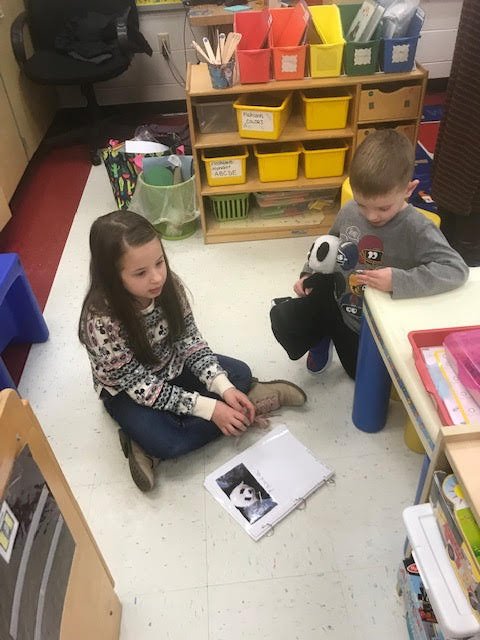 2nd graders reading their expert books to pre-k