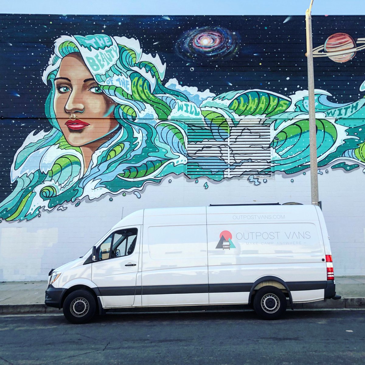 OutpostVans's tweet photo. This mural has us feeling like... “I’m a traveler of both time and space!” Name that tune! 🚀🌊🌙 #campervan #campervanlife #vanlife #camping #offgrid #tinyhome #beach https://t.co/HhNu9abSaS