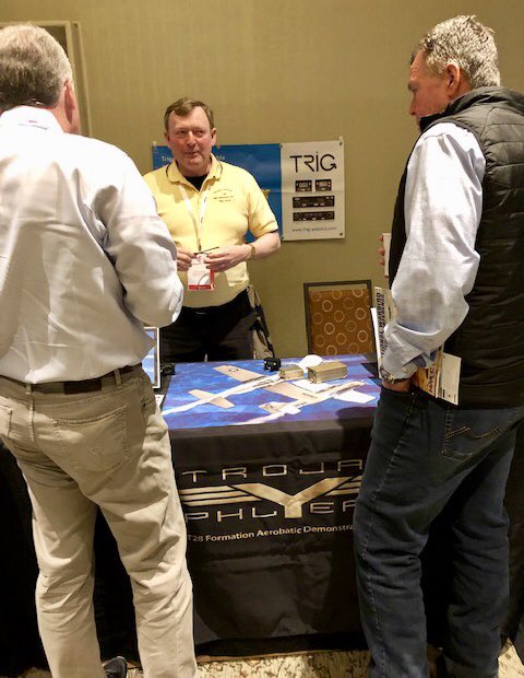 TrojanPhlyers's tweet photo. Chip Lamb represented our team at the National Warbird Operator Conference in Tucson - in the Snow- today. While talking about our team and Trojan T-28 warbirds we are also telling people about our new sponsor Trig Avionics! #trojanphlyers #t28 #warbirds #avionics #trigavionics https://t.co/2BomVNhYtD
