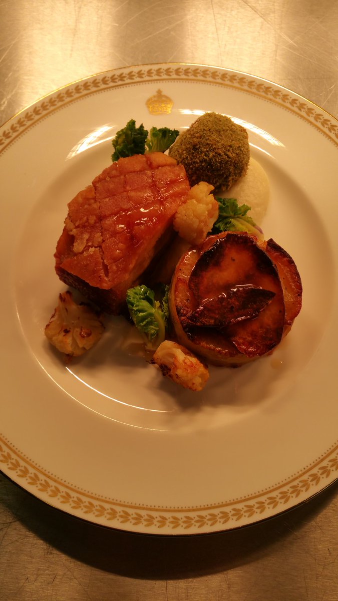 Roast pork belly with a haggis bonbon, roasted cauliflower puree, baby kale, pommes Anna with a port jus