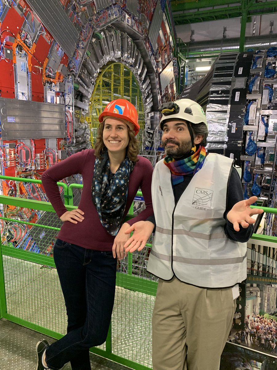 Me and Andre standing in front of the detector. We’re both looking a bit to the side. I’m trying to look cool and Andre is sort of shrugging and looking amused. He’s wearing a rainbow scarf and a white “CMS GUIDE” reflective vest and a hard hat with a light on it.