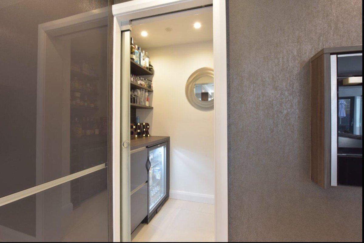 DBKitchens's tweet photo. Have a 👀 at this recently completed kitchen with a matching hidden #cocktailroom #winechiller 🍸#glassfronteddoors @Dekton #worktops #roundbreakfastbar @TONONitalia #barstools @TomDixonStudio #pendantlighting @NEFFHomeUK @quookeruk #boilingwatertap #kitchendesign https://t.co/BSfpnKLZpz